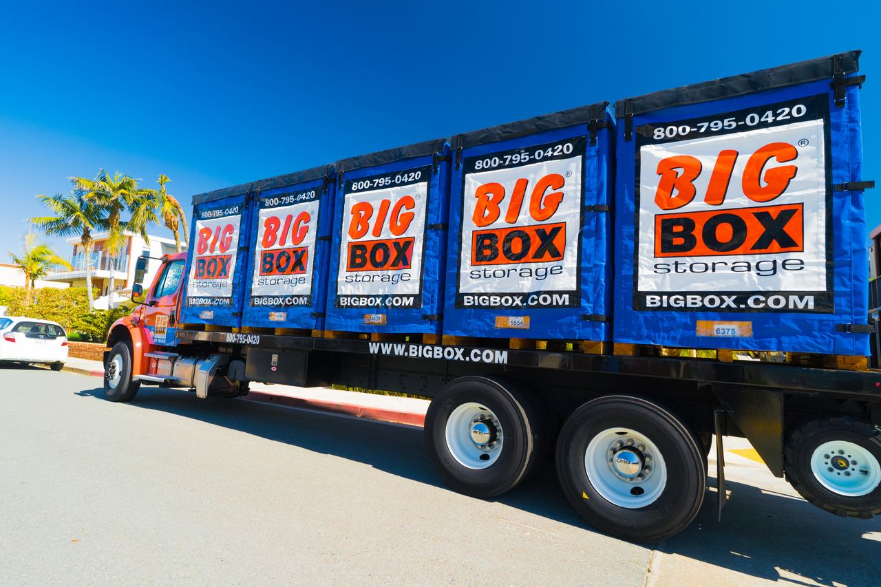 Big Box Storage truck loaded with branded portable storage containers on a San Diego street